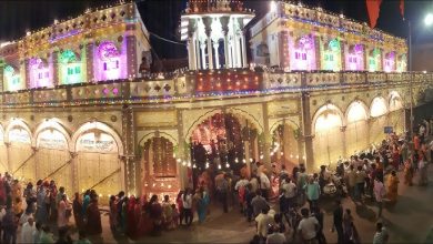 Devotees walking in a vibrant Ram Navami procession with colorful floats and traffic police guiding the crowd in Nagpur.