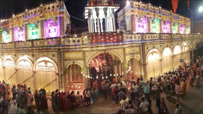 Devotees walking in a vibrant Ram Navami procession with colorful floats and traffic police guiding the crowd in Nagpur.