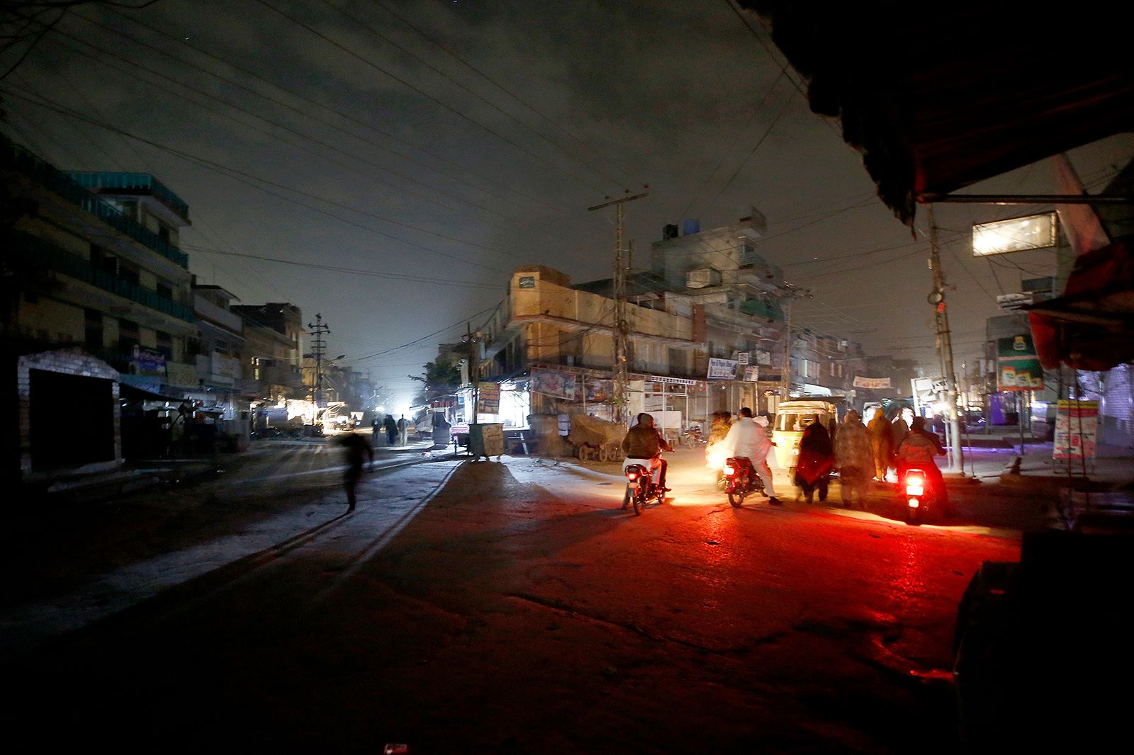 Image of a cityscape during a heavy downpour, with dark clouds and lightning in the background, symbolizing the challenges faced during power outages in Nagpur.