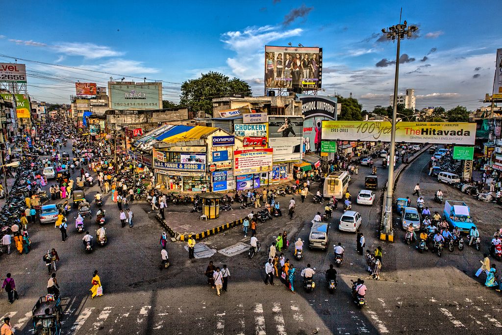 Nagpur: A bustling cityscape with a modern multi-storey parking plaza in the foreground, symbolizing Nagpur's smart parking solutions. | NSSCDCL