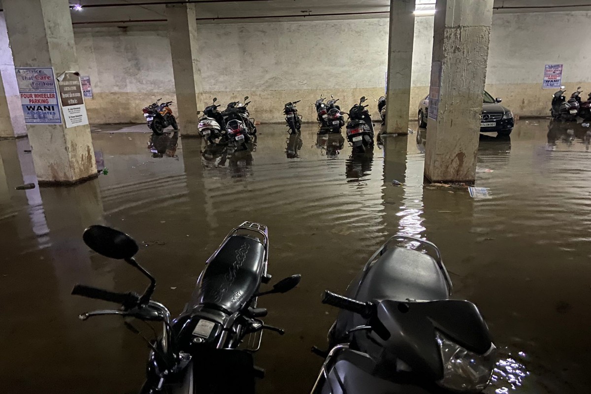 NMC team draining water from a flooded basement in Nagpur.