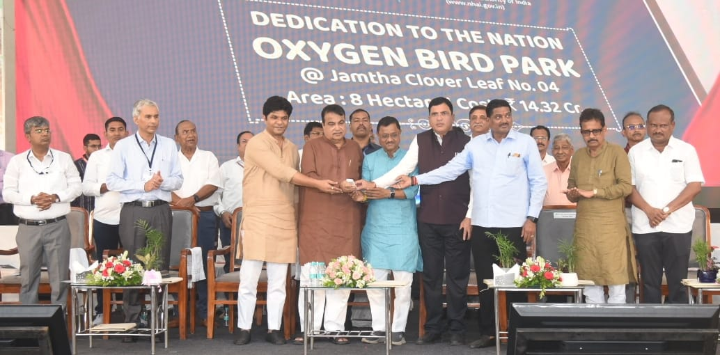 Mukesh Ambani launching a rice straw-based CNG project amidst green surroundings.