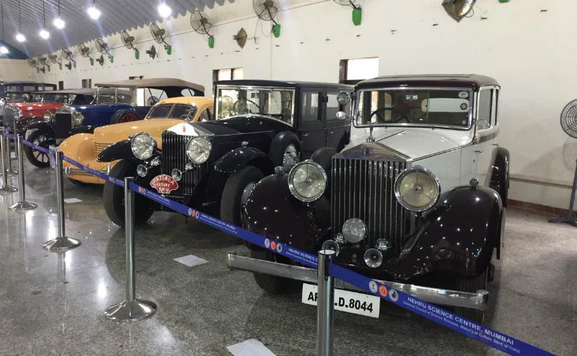 A lineup of beautifully restored vintage cars and bikes at an exhibition. Raman Science Centre | Vintage Car and Bike Display