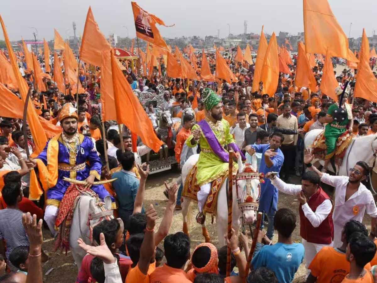 A vibrant procession celebrating Shiv Jayanti in Nagpur, featuring traditional performances and enthusiastic participants.
