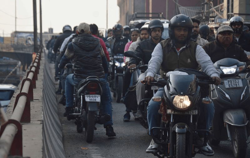 Nagpur traffic police enforcing road safety rules with penalties for wrong-side driving and signal violations.